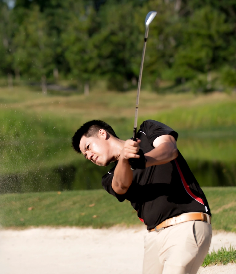 Golfer hits a shot from a sand bunker during a charity golf tournament at Wings of Eagles Ranch.