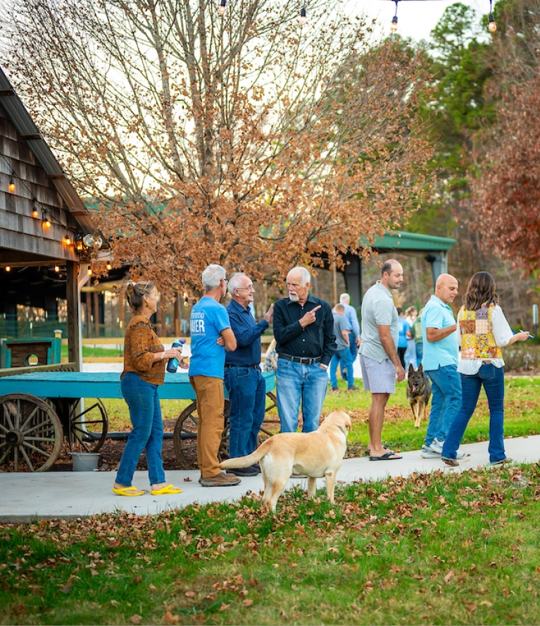 Guests gather and socialize outdoors during the Harvest Hoedown at Wings of Eagles Ranch.